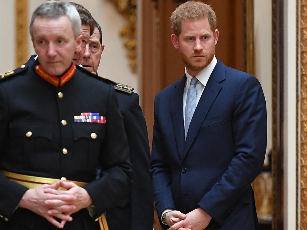 Prince Harry looks on as US President Donald Trump views US items of the Royal Collection.