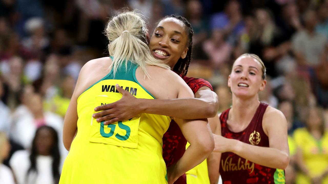 Donnell Wallam of the Australia Diamonds embraces Layla Guscoth of England Roses.