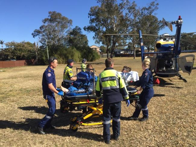 A man is loaded into a CareFlight helicopter after suffering serious burns at a Bidwill construction site.