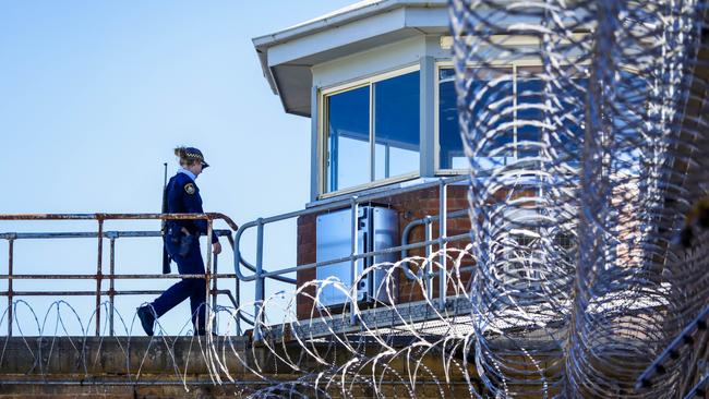 An armed guard on duty at the Goulburn jail. Picture by Sean Davey.