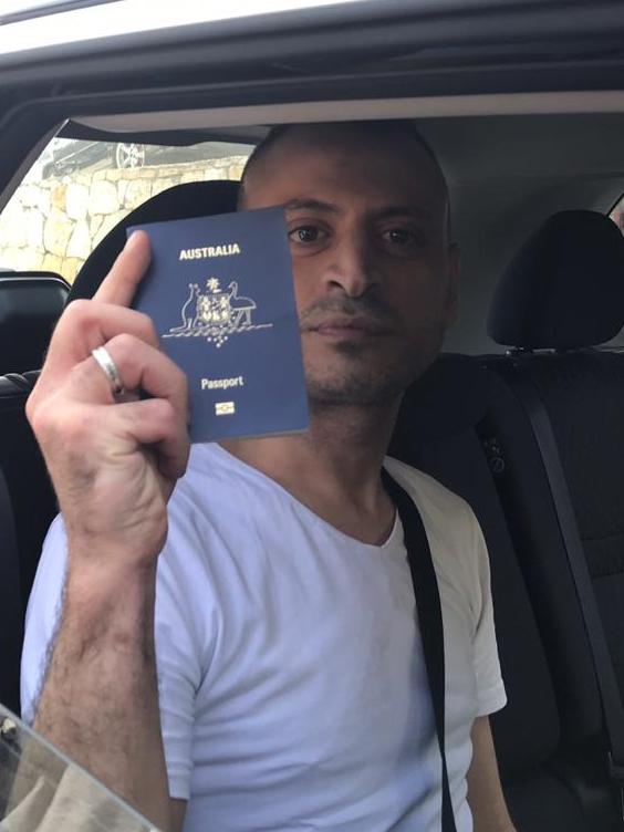 Amer Khayat shows his Australian passport after his release from jail before returning to Australia. Picture: Stephen Drill