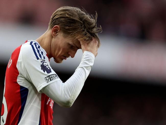 Arsenal's Norwegian midfielder #08 Martin Odegaard reacts after the English Premier League football match between Arsenal and West Ham United at the Emirates Stadium in London on February 22, 2025. West Ham won the match 1-0. (Photo by Ian Kington / IKIMAGES / AFP) / RESTRICTED TO EDITORIAL USE. No use with unauthorized audio, video, data, fixture lists, club/league logos or 'live' services. Online in-match use limited to 45 images, no video emulation. No use in betting, games or single club/league/player publications.