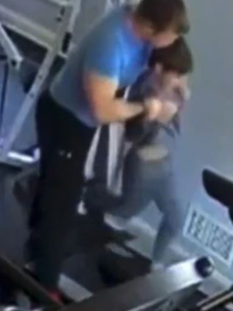 Christopher Gregor appears to bite his son’s head as he places the child on a fast-moving treadmill on March 20, 2021.