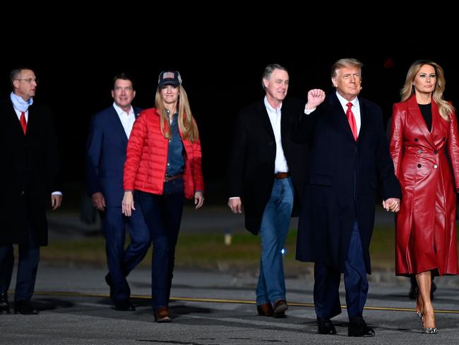 US President Donald Trump holds up his fist as he arrives with First Lady Melania Trump and Georgia Republican Senators David Perdue and Kelly Loeffler. Picture: AFP