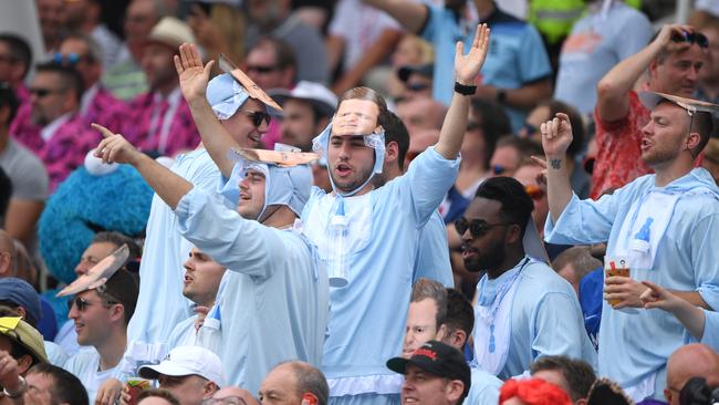 England fans with masks that show Steve Smith crying during his press conference last year after the ball-tampering scandal. Picture: Getty Images