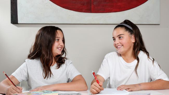 Sisters Isabella Lipari, a year 5 student and Lily Lipari, a year 6 student (right), doing homework at home in St Ives. Isabella will not be doing NAPLAN this year and her mother is relieved. Picture: Jonathan Ng