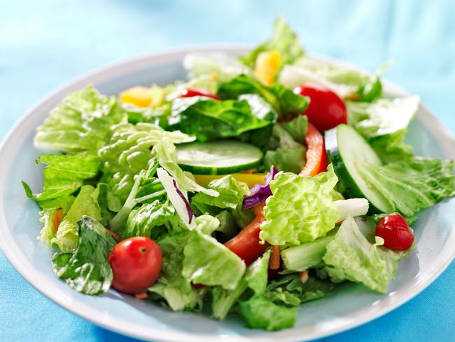 close up photo  of a garden salad with fresh vegetables with copy space composition