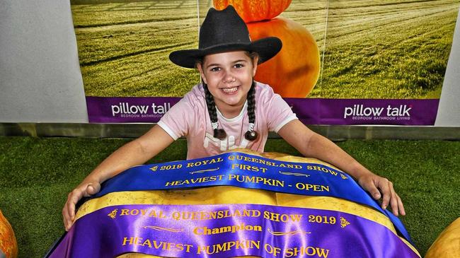 MAMMOTH: Kyla-Shaye Fritz of Thagoona won the youth class for her champion pumpkin. Picture: Contributed