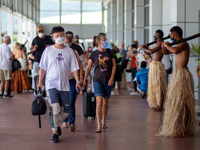 Traditional dancers in grass skirts welcome holiday-makers in Nadi on Wednesday as Fiji opens its borders to international travellers for the first time since the Covid-19 pandemic swept the globe and devastated its tourism-reliant economy. Picture: Leon LORD / AFP