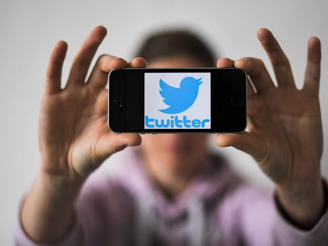 A woman holds a smartphone with the logo of US social network Twitter, on May 2, 2019 in Nantes, western France. (Photo by LOIC VENANCE / AFP)