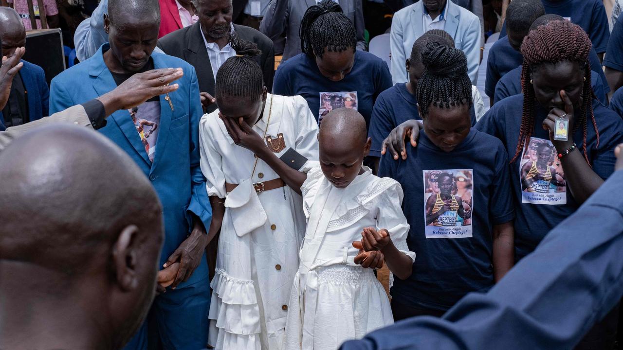 Charity Chebeti, 8 and Joy Cheptoe, 12, daughters of Rebecca Cheptegei, react during the burial ceremony. Photo by Badru KATUMBA / AFP.