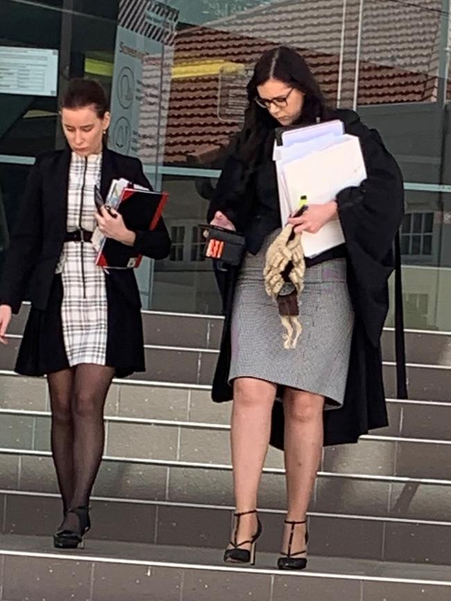 Crown prosecutor Tiffany Lawrence (right) leaves court with a Director of Public Prosecutions employee.