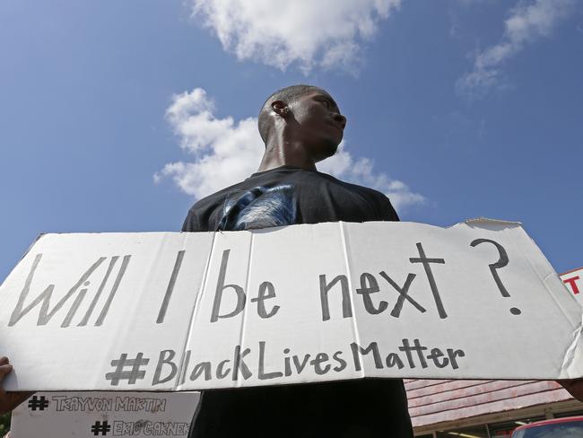 Niamke Ledbetter, of Oak Cliff, Texas, holds a sign at a Black Lives Matter protest on Park Lane in Dallas, Texas on Sunday. Picture: Jae S. Lee/The Dallas Morning News via AP