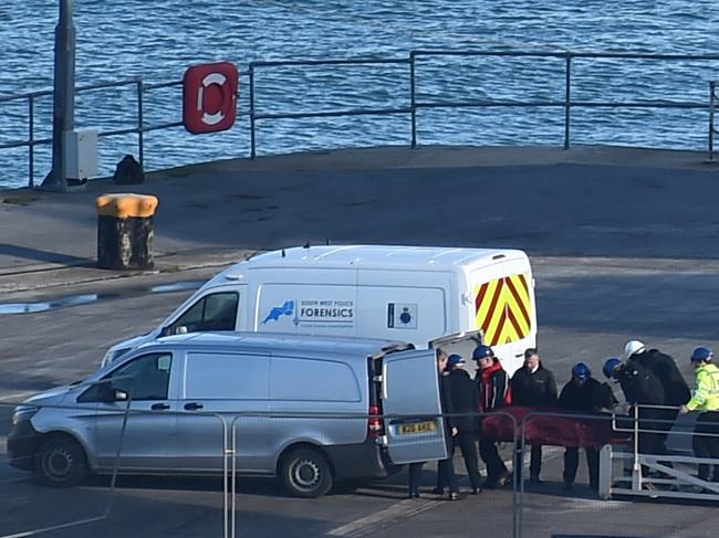 A body is taken off the Geo Ocean III, recovered from the wreckage of a plane carrying Argentine footballer Emiliano Sala at Weymouth harbour, south west England on February 7, 2019. - A body recovered by British investigators from the submerged wreckage of a plane that went down in the Channel has been identified as that of footballer Emiliano Sala, police said on February 7, 2019. The Argentine striker's body was first spotted by rescuers with a remotely operated vehicle (ROV) on Sunday close to where the plane went missing near the British island of Guernsey. (Photo by Glyn KIRK / AFP)