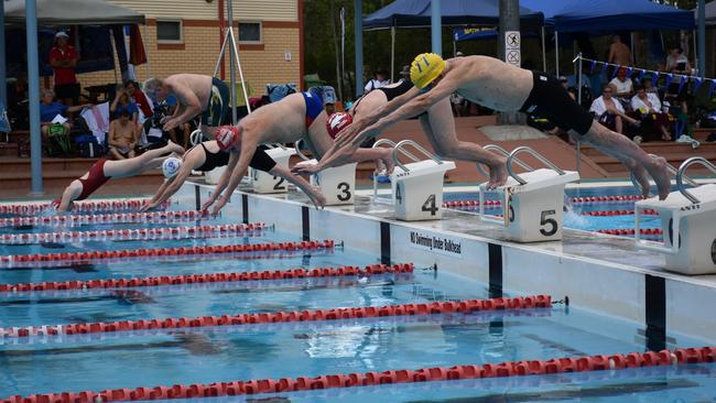 George Corones (yellow cap) executes a text book dive at the start of the 25m breaststroke at Albany Creek Masters Swimming’s (ACMS) Short Course Meet on Saturday.