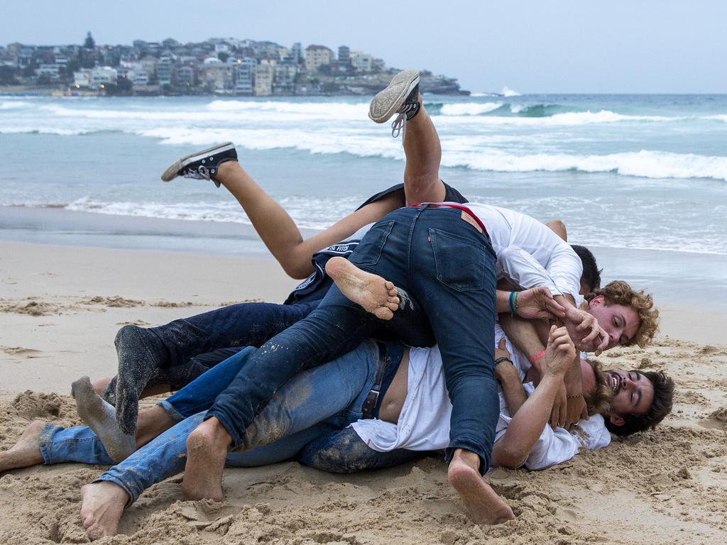 People wrestle in the sand at Bondi Beach on New Year’s Day, 2020 Picture: Jenny Evans/Getty