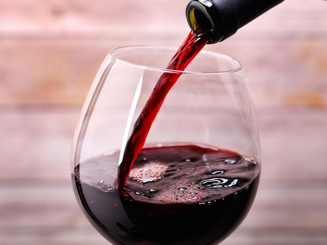 Pouring red wine int a glass