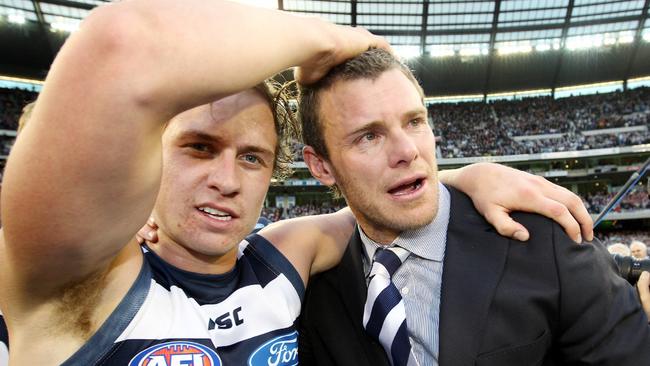 A teary Mooney with Mitch Duncan during Geelong’s celebrations.