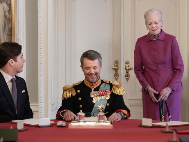 Prince Christian casts a comforting eye to Queen Margrethe II, who was brought to tears by her final act as Monarch. Picture: AFP