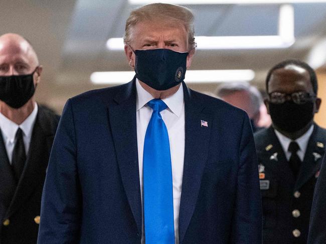 (FILES) In this file photo taken on July 11, 2020 US President Donald Trump wears a mask as he visits Walter Reed National Military Medical Center in Bethesda, Maryland. - US President Donald Trump said early on October 2, 2020 that he and First Lady Melania had tested positive for the coronavirus. (Photo by ALEX EDELMAN / AFP)