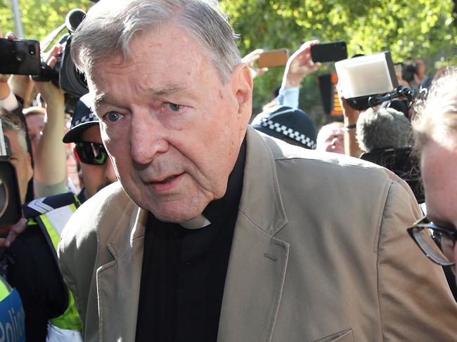 TOPSHOT - Cardinal George Pell (C) makes his way to the court in Melbourne on February 27, 2019. - Cardinal George Pell arrived in court, possibly for the last time as a free man, in a last-ditch push to apply for bail after his historic conviction for child sex crimes. (Photo by Con CHRONIS / AFP)