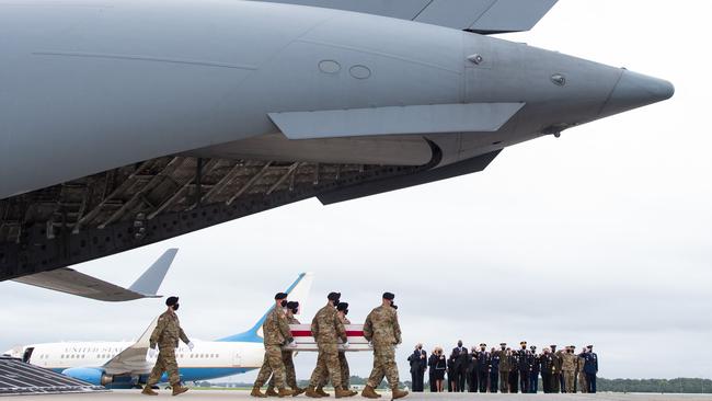 The coffin of a US service member is brought onto the tarmac at Dover Air Force Base in D Delaware. Picture: AFP