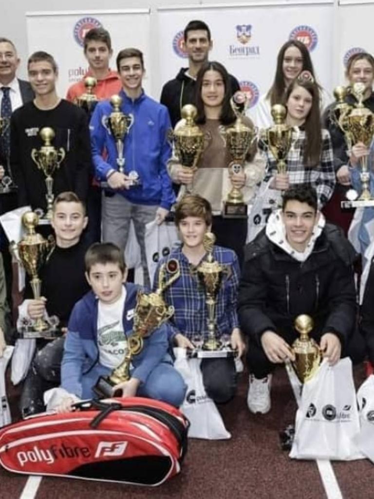 Djokovic (top, middle) attended an award ceremony for children at the Novak Tennis Centre on December 17.