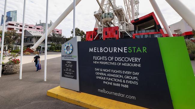 Signage remains in front of the Melbourne Star Wheel at Docklands, even though it no longer spins. Picture: Ian Currie