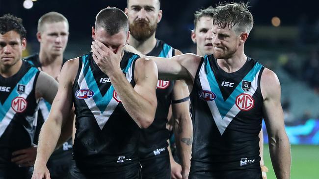 Brad Ebert with tears in his eyes is consoled by Tom Jonas as they walk off after the loss Picture: Sarah Reed