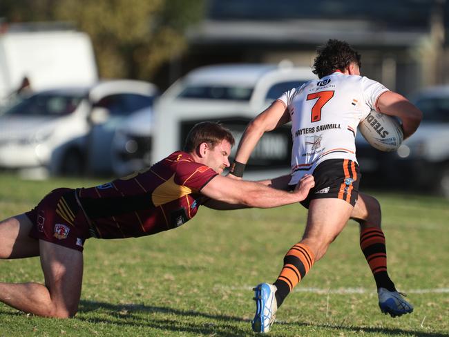 Tigers halfback Daniel Payne escapes the grasp of Thirlmere captain Kye Madden. Picture Warren Gannon Photography