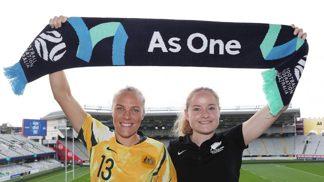 Tameka Yallop of Australia (L) and Paige Satchell of New Zealand (R) pose for photographs at Eden Park in Auckland on June 26, 2020, after Australia and New Zealand won hosting rights for the 2023 Women's football World Cup. (Photo by MICHAEL BRADLEY / AFP)