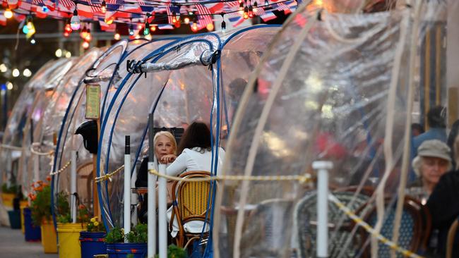 People dine in plastic tents for social distancing at a restaurant in Manhattan in New York City. Picture: AFP