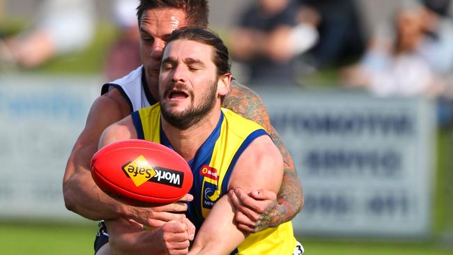 Mornington Peninsula Nepean Football League defender Kevin Lylak gets a handball away against Northern Football League last year. Picture: David Trend