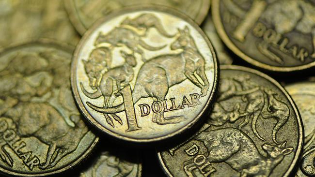 Close-up of used Australian one dollar coin photographerd in Melbourne, Wednesday, June 13, 2012. Reserve Bank of Australia governor Glenn Stevens today said there are big benefits to Australian's as consumers from the high Aiustralian dollar (AUD). (AAP Image/Julian Smith) NO ARCHIVING