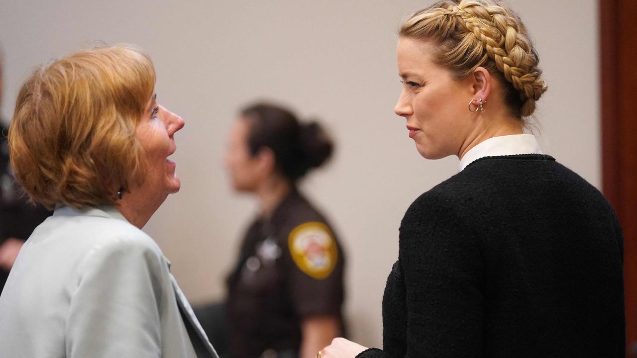 Amber Heard (right) speaks to a member of her legal team today. Picture: