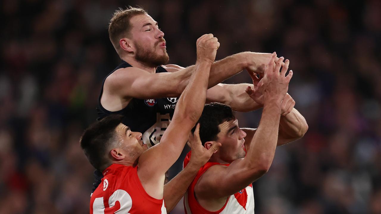 MELBOURNE, AUSTRALIA - September 8, 2023. AFL . 1st Elimination Final.     Harry McKay of the Blues collides with Sydneys Tom McCartin and  Lewis Melican causing McKay to leave the ground injured  during the elimination final between Carlton and Sydney Swans at the MCG in Melbourne, Australia.  Photo by Michael Klein.