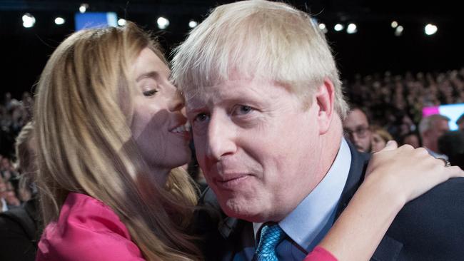 Carrie Symonds embraces Boris Johnson after his keynote speech at the Conservative Party conference. Picture; AFP.