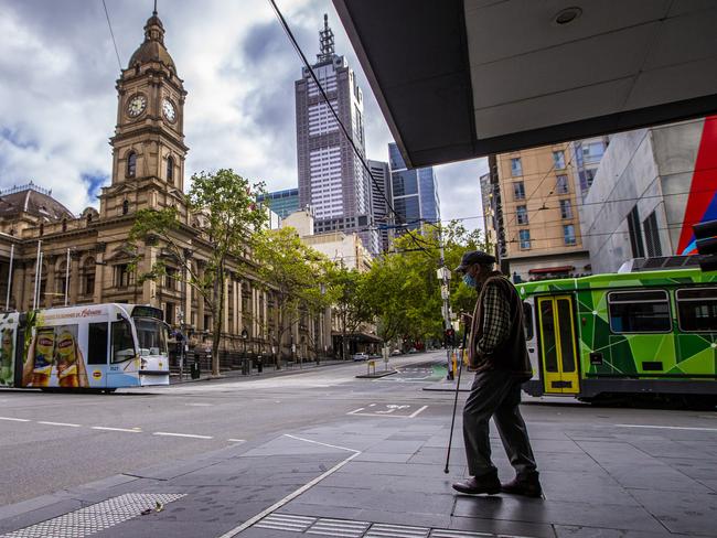 MELBOURNE, AUSTRALIA - FEBRUARY 14: A man walks along the sidewalk in the central business district on February 14, 2021 in Melbourne, Australia. Victoria is in stage 4 lockdown from as of Saturday for five days following the confirmation of new COVID-19 cases of the UK virus strain in the community linked to the Holiday Inn quarantine hotel. Victorians are only able to leave their homes for essential shopping, caregiving, essential work or permitted education, or exercise for two hours per day with household members only. People must stay within a 5km radius of home. The stage 4 restrictions are due to end at 11:59pm on Wednesday 17 February. (Photo by Wayne Taylor/Getty Images)