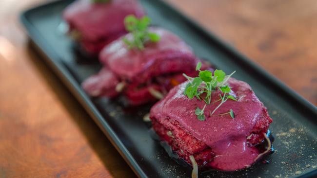 Thick slices of paneer in deep ruby beetroot sauce.