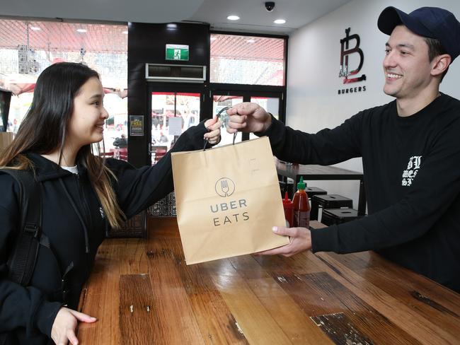 Bar Luca and a range of other Parramatta retaurants will be using UberEats to deliver food to customers. Pictured is RAchel Lin from Uber Eates with Store Manager of BL Burgers Aleks Lemaic.