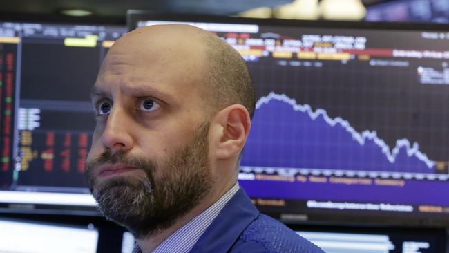 Specialist Meric Greenbaum works on the floor of the New York Stock Exchange and saw the Dow Jones drop more than 600 points. Picture: Richard Drew