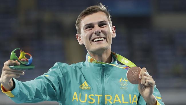 Dane Bird-Smith celebrates on the podium after the men's 20km race walk. Picture: AP