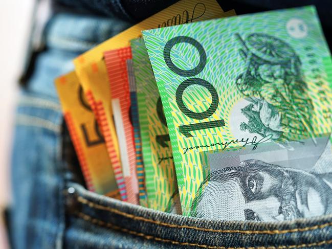 Australian cash money in mans jeans pocket, close up.