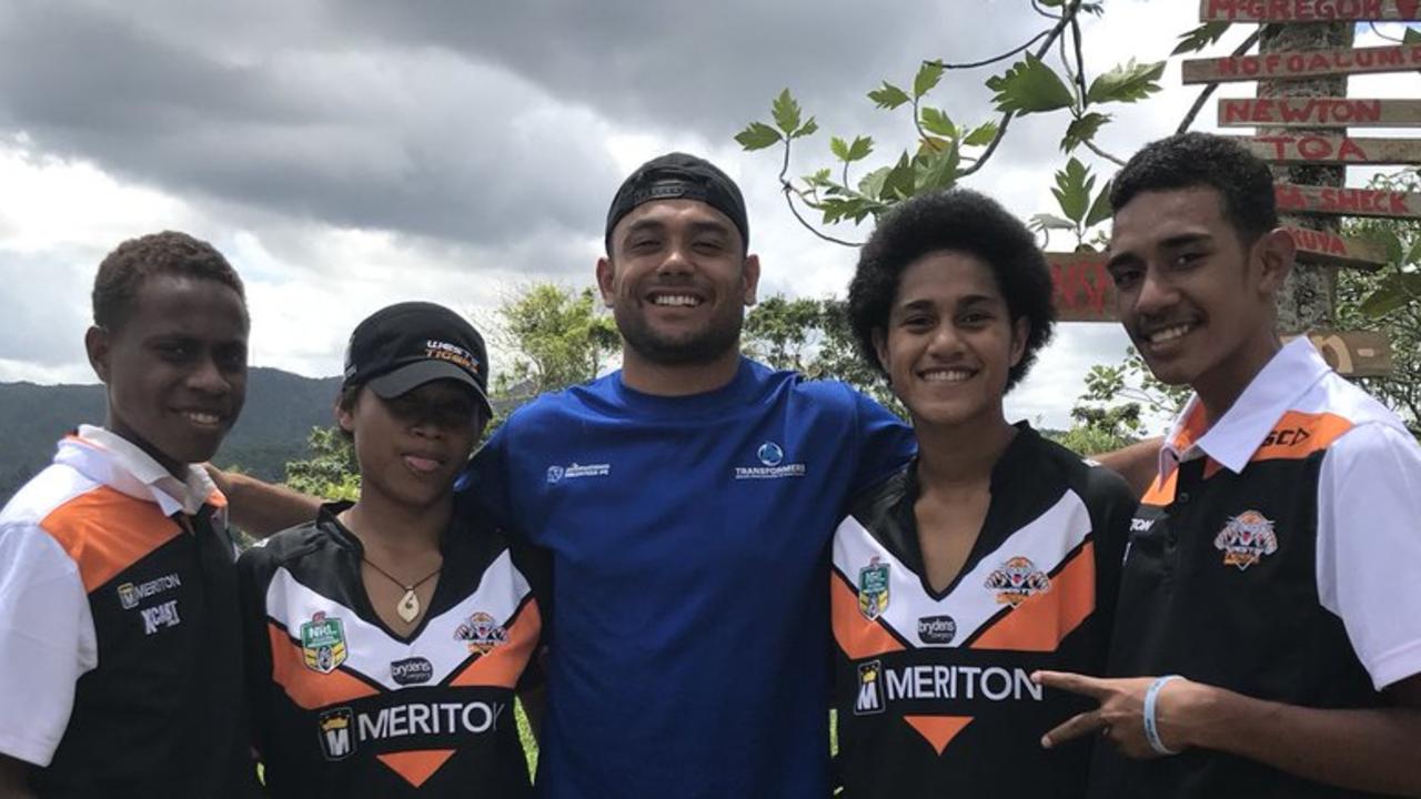 David Nofoaluma hands out Wests Tigers gear to Fiji locals.