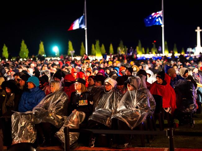 Australian family members wait for the Anzac Day ceremonies to start at the military cemetery of the Australian National Memorial in Villers-Bretonneux. Picture: AFP