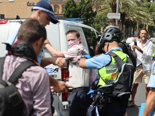 A protester is arrested outside the St Mary's Cathedral service. Picture: Nicholas Eagar