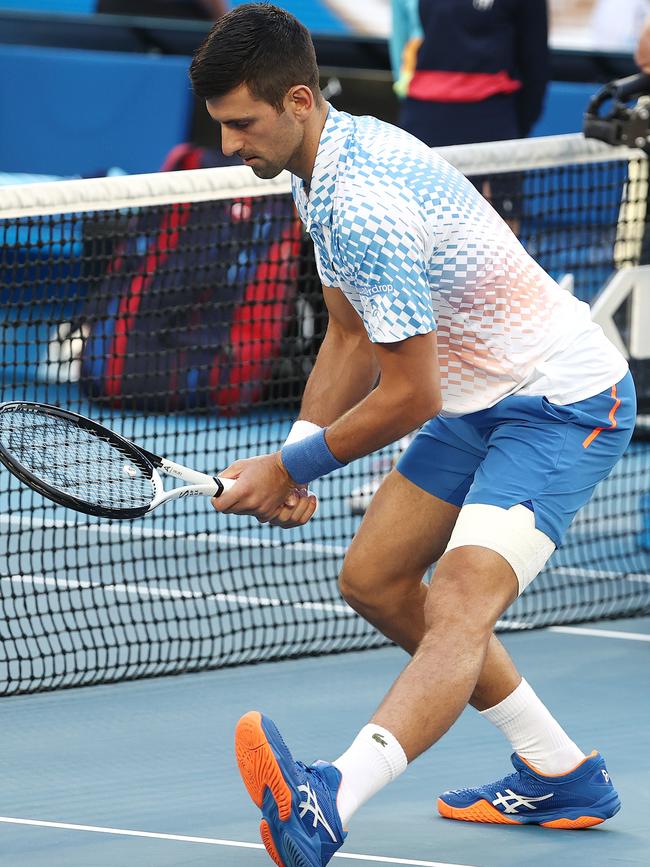 Djokovic stretches his injured left hamstring before a match. Picture: Michael Klein