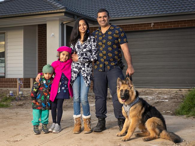 MELBOURNE, JUNE 20, 2024: The Melbourne council area of Casey has been revealed as the state's most prolific for new housing approvals. Sandeep Singh Chauhan and Aakanksha Sharma with their children Serena, 6, and Veer, 4, and dog Leo outside their Clyde property that is still under construction. Picture: Mark Stewart