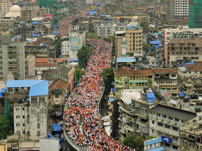 Indian members of the Maratha community in the state of Maharashtra cross a flyover as they take part in a rally in Mumbai on August 9, 2017. The Maratha Kranti Morcha silent protest is being held to demand emplyoment quotas for the Maratha in state-run education institutions and government jobs, a minimum support price for farm produce, and amendments to the Scheduled Castes and Scheduled Tribes (Prevention of Atrocities) Act. Picture: AFP PHOTO