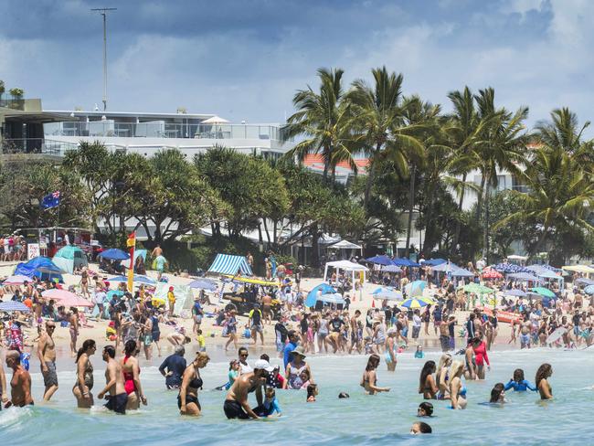 Holiday crowds pack into Noosa’s Main Beach on New Year’s Day.